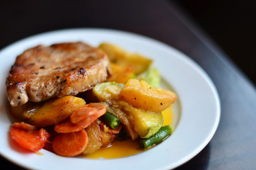 tasty meat with potatoes and vegetables on a white plate macro