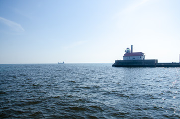 A cargo ship passing through duluth with a view of the lighthouse