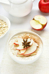 Oats porridge with red apple slices and cinnamon