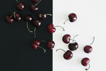 cherry on black and white background flat lay