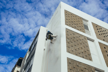 man climb on building