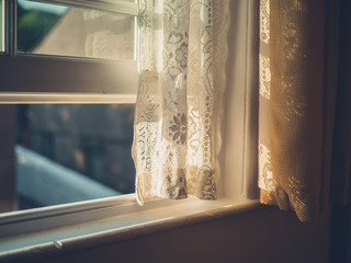 Sunlight hitting curtain by window