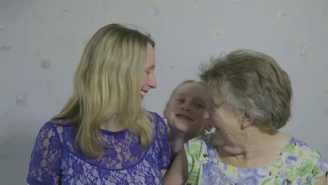 Three generations of the same family looking at the camera