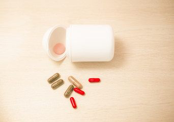 Pharmacy background on a wood table.Pills. Medicine and healthy. Close up of capsules. 