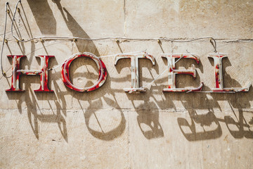 Hotel. Grungy advertising neon sign