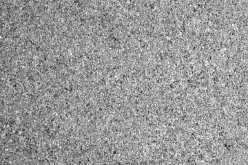 Cork board surface in black and white.