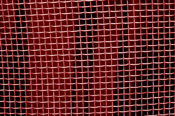 Metal mesh grid pattern in red tone.