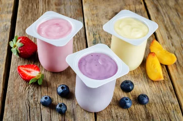 Fototapeten Variation of fruit yoghurts: strawberry, blueberry and peach © nata_vkusidey