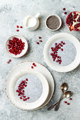 Healthy breakfast set. Chia seed pudding bowls with pomegranate.