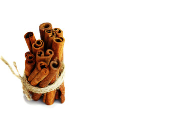 Cinnamon sticks tied with jute rope on isolated white background