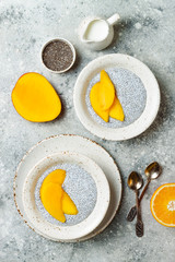 Healthy breakfast set. Chia seed pudding bowls with mango.