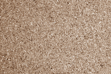 Cork board surface in brown tone.