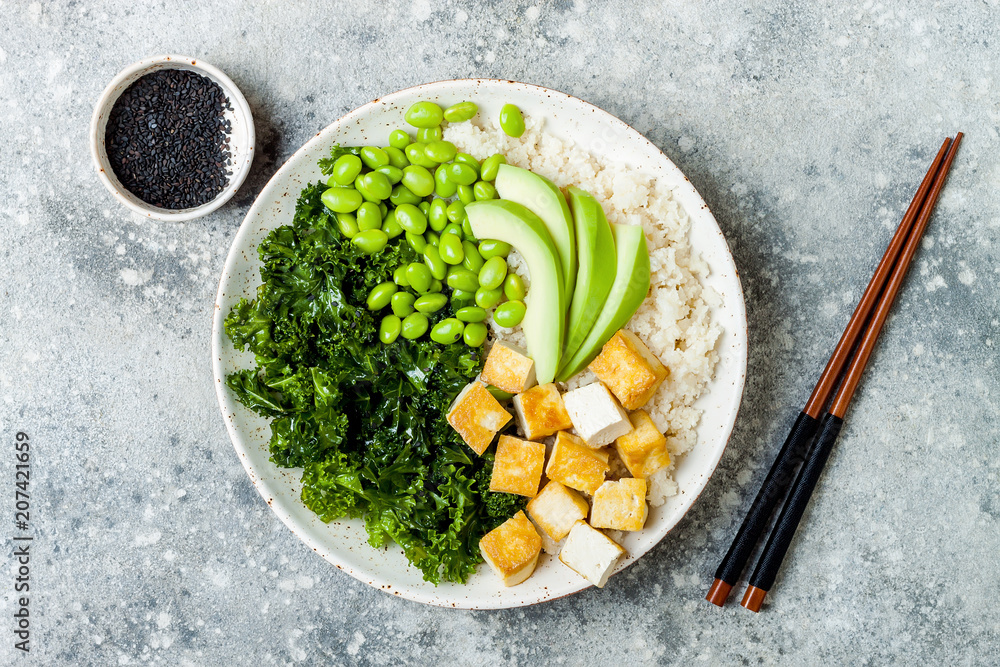 Sticker Cauliflower rice Buddha bowl with massaged kale, tofu, avocado and edamame beans. Vegan poke bowl