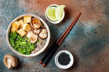Miso and soba noodles soup with kale, shiitake mushrooms, .roasted tofu