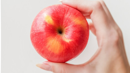Ripe red apple in hand