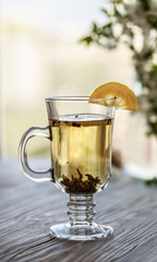 Fresh green tea. Tea cup with green tea leaf on the wooden table. Tea with lemon