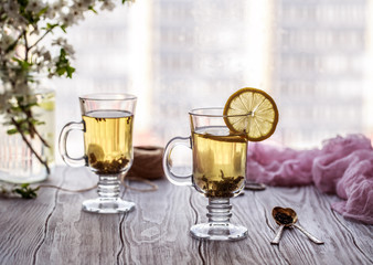 Fresh green tea. Tea cup with green tea leaf on the wooden table. Tea with lemon