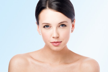 Obraz premium Beauty portrait of a young beautiful woman with a light smile. Nude makeup and perfect skin.