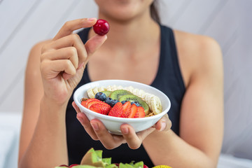 Selected focus on women hand hold a fresh fruits. Healthy food concept.