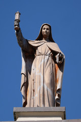 Saint Clare of Assisi statue on Franciscan church in Shkoder, Albania. - obrazy, fototapety, plakaty