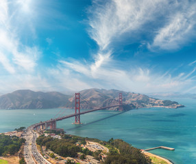 Aerial overhead view of San Francisco Golden Gate Bridge and city traffic from helicopter
