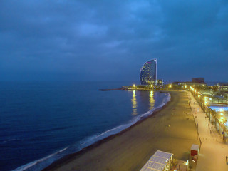 Barcelona port in Barceloneta. Aerial view of oceanfront at night
