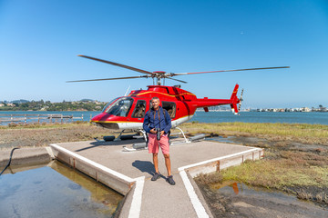 Happy man ready to take helicopter flight