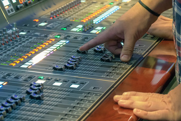 Sound control panel professional. Sound designer working on the sound control. Man working on...