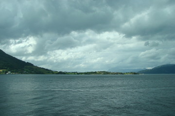 Sea landscape near the coast of Norway on the background of the cloudy northern Scandinavian sky.