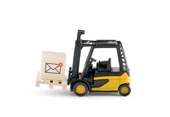 Yellow forklift with new email graphic on wooden block over white background © Jakub Krechowicz