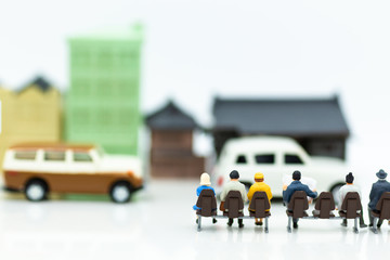 Miniature people : people waiting for bus at bus station using as background travel, business trip or transportation concept.