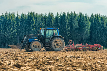 Picture of farmer plowing stubble field