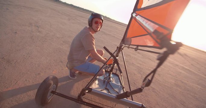 Professional land sailing athlete preparing blokart for beach race