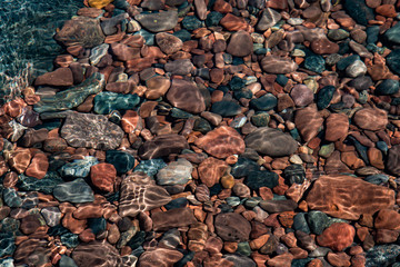 Colorful Stones Through Sunny Reflective Water