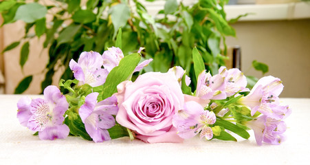 Beautiful bouquet of  pink alstroemeria and rose flower on linen cloth