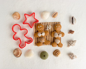 Smiling gingerbread men, cookies for the holiday, decor with sugar and seashells.