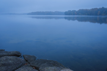dark blue foggy morning on the lake