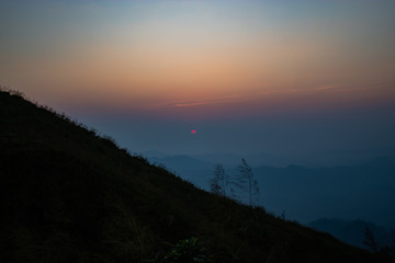 Obraz premium Light sunset behind the mountains Nern Chang Suek hills, Kanchanaburi, Thailand