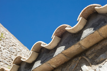 Detail of clay roof tiles from a mediterranean country house on a sunny day