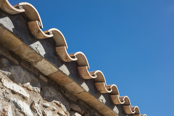 Detail of clay roof tiles from a mediterranean country house on a sunny day