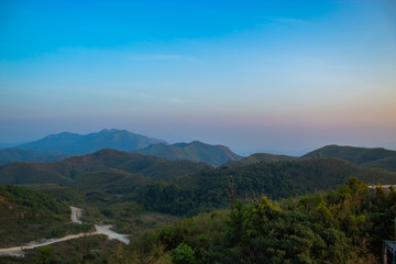 Fototapeta premium Light sunset behind the mountains Nern Chang Suek hills, Kanchanaburi, Thailand