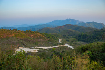 Fototapeta premium Light sunset behind the mountains Nern Chang Suek hills, Kanchanaburi, Thailand