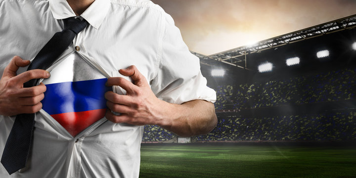 Russia soccer or football supporter showing flag under his business shirt on stadium.