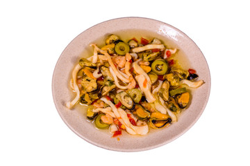 Ceramic plate with the different sea food and olives isolated on white background