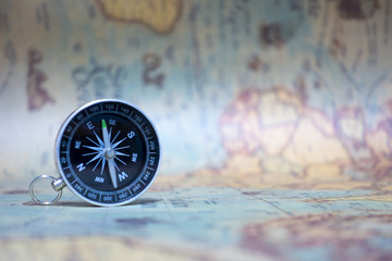 Fototapeta na wymiar Compass on world map for traveling background.