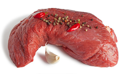 Raw beef piece with spices isolated on a white background. 