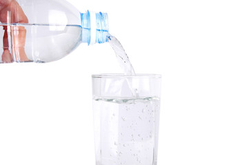 Clean drinking water from safe plastic bottles. Pouring into a glass.