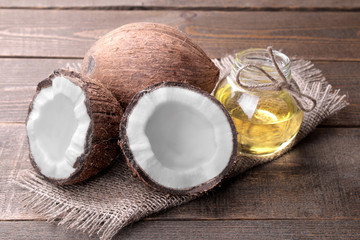 Coconut with coconut oil on a brown wooden background