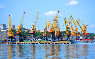 yellow cranes for lifting cargo at the sea port.  City Odessa, Ukraine 18 July 2013