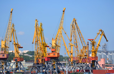 yellow cranes for lifting cargo at the sea port.  City Odessa, Ukraine 18 July 2013